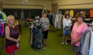 Nancy Robert (right) with (from left) Lynda Briggs, Julie Crandall and Pat McCraith, who have been preparing the boutique for reopening.